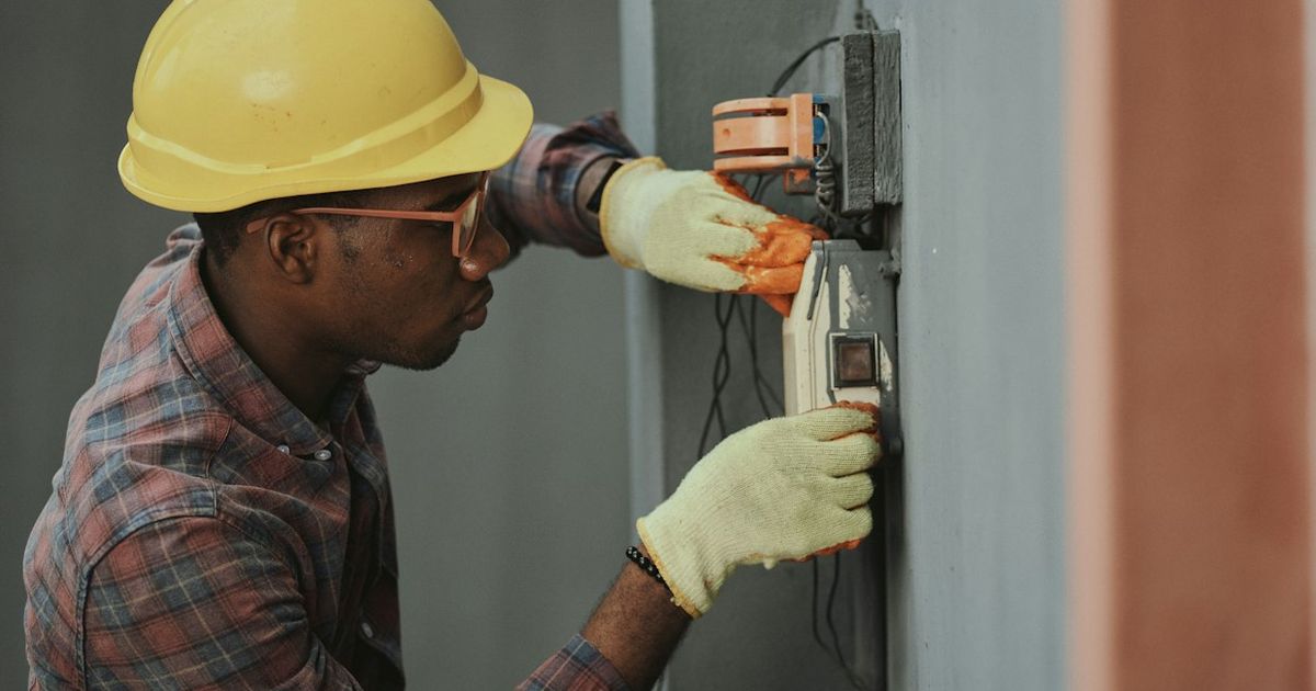 HVAC technician installing a modern air conditioning unit